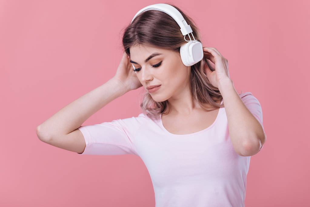 beautiful blonde woman in white headphones listens to music - Photo, Image