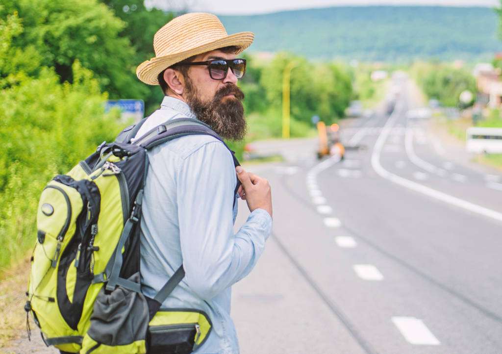 Missed his bus. Tips of experienced traveler. Man bearded hipster tourist at edge of highway. Pick me up. Traveler waiting for car take him anyway just to drop at better spot - Photo, Image