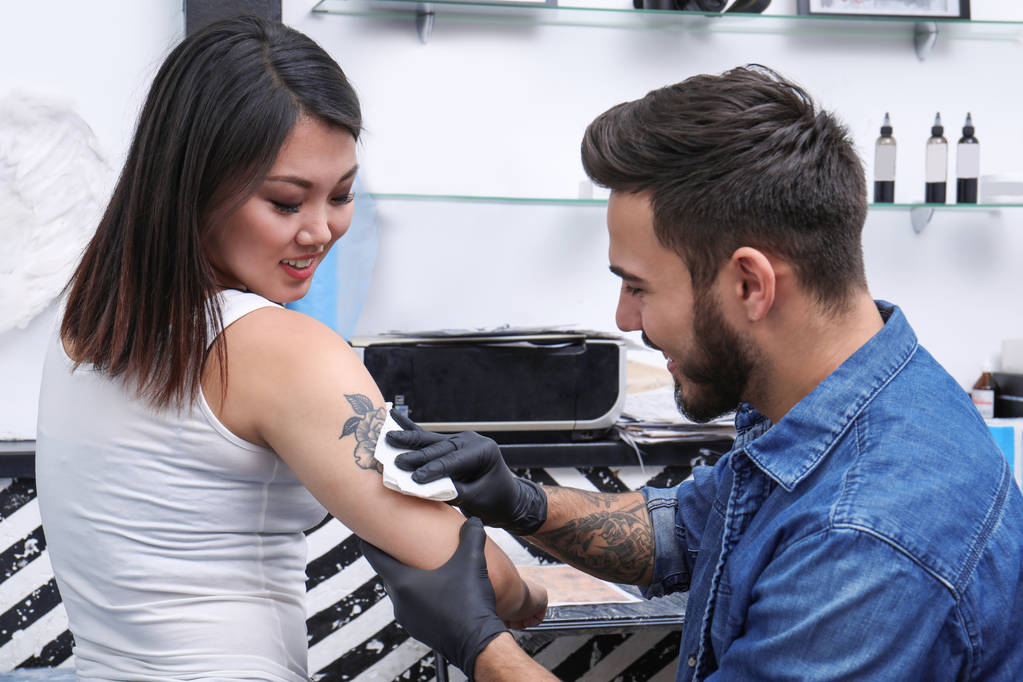 Professional artist making stylish tattoo in salon - Photo, Image