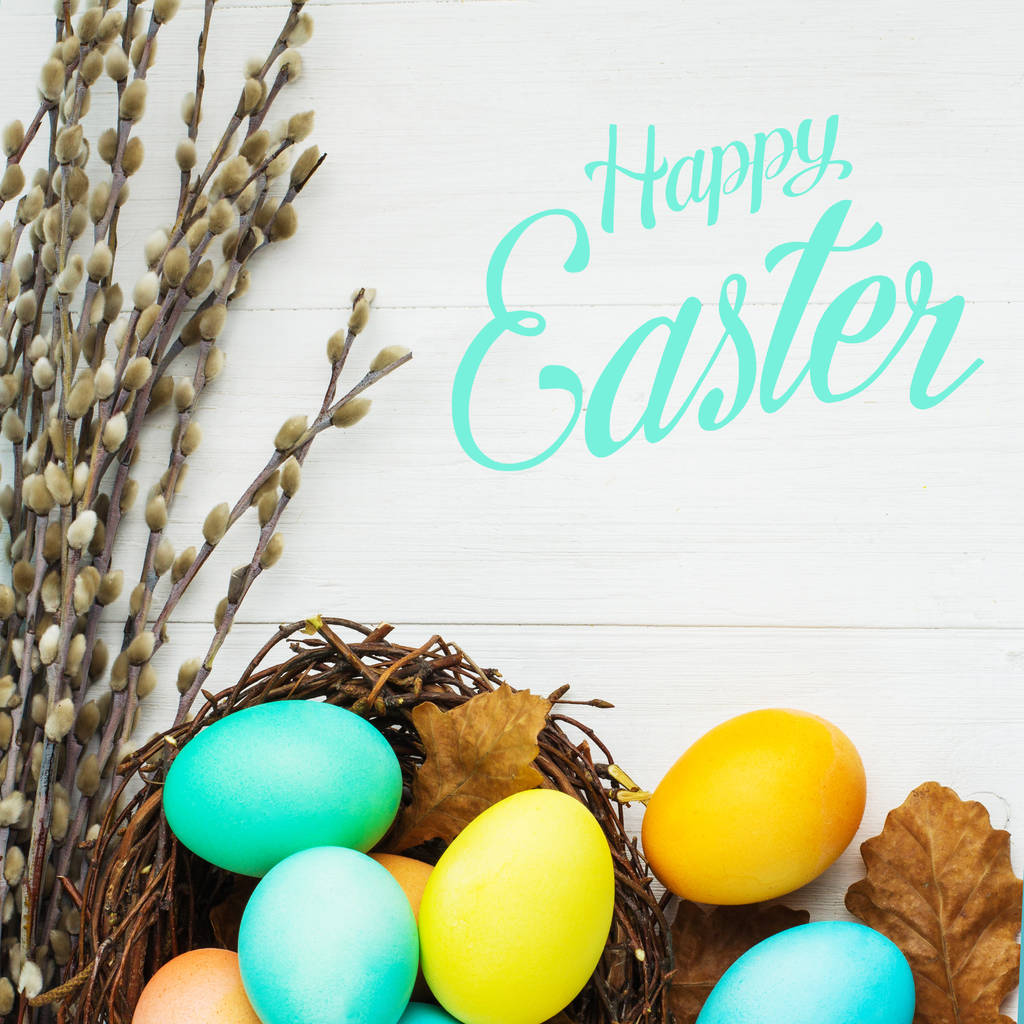 huevos de Pascua de colores en el nido en una mesa blanca, vista superior
 - Foto, imagen