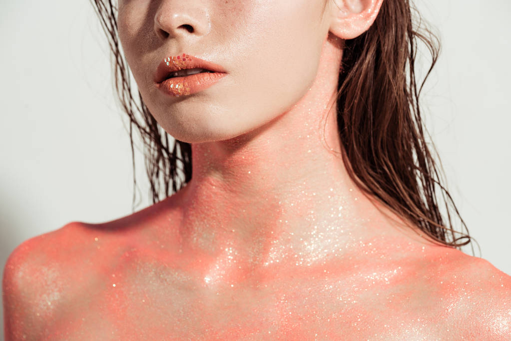 cropped view of nude woman with coral glitter and wet hair isolated on grey - Photo, Image