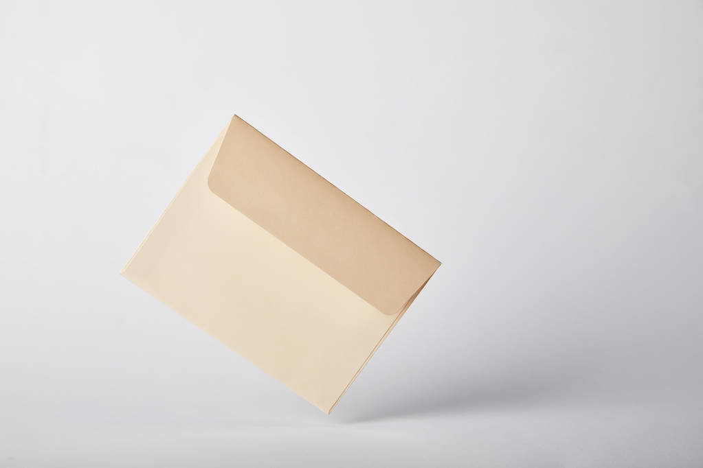 beige and empty envelope on grey background with copy space  - Photo, Image