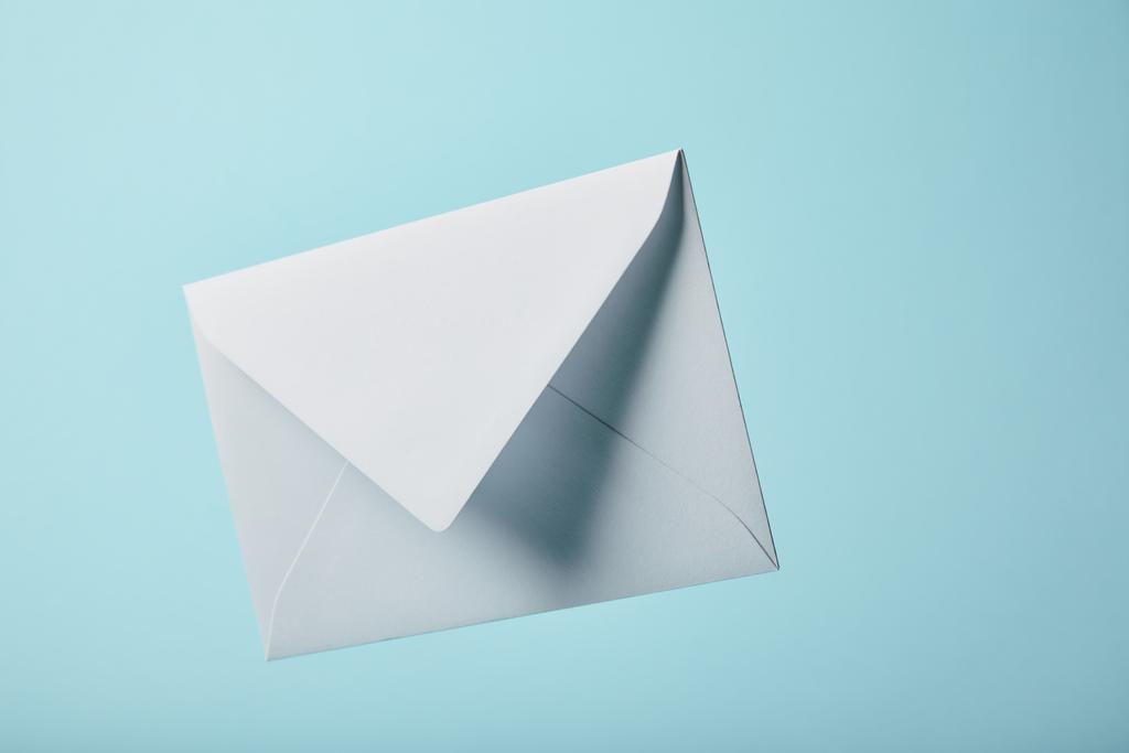 white and blank envelope on blue background with copy space  - Photo, Image