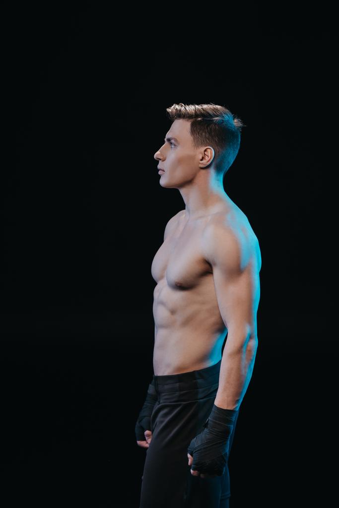 schöner muskulöser Sportler in Bandagen mit nacktem Oberkörper isoliert auf schwarz - Foto, Bild