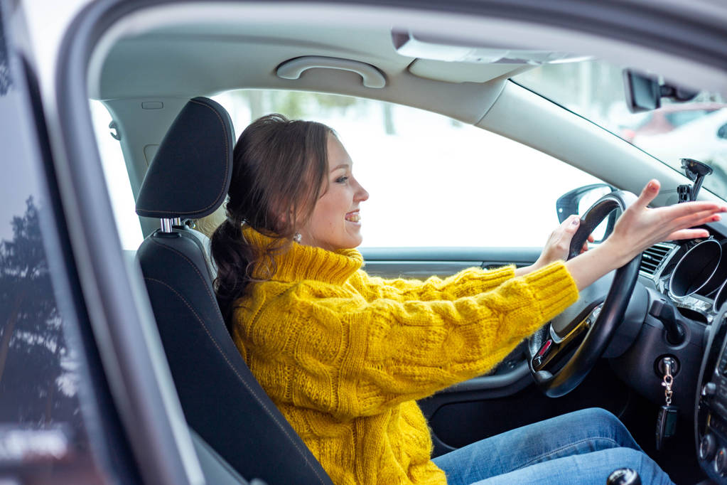 Молодая девушка водит современную машину и улыбается
 - Фото, изображение
