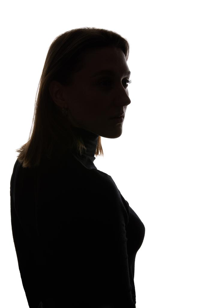 Silhouette einer nachdenklichen Frau, die isoliert auf Weiß wegschaut - Foto, Bild