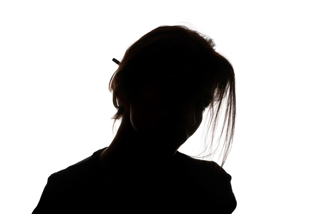 Silhouette einer Frau, die isoliert auf weiß in die Kamera blickt - Foto, Bild