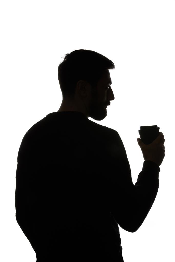 白に分離されたコーヒーの紙コップを持つ男のシルエット - 写真・画像