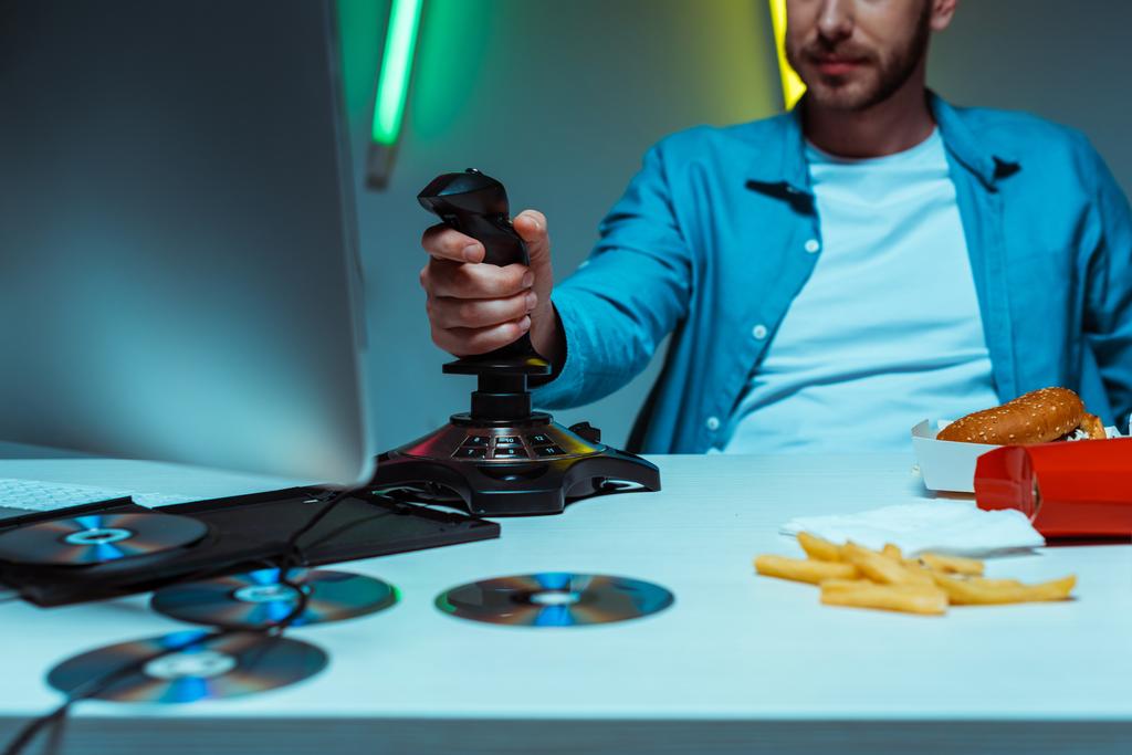 selective focus of man playing video game with black joystick - Photo, Image