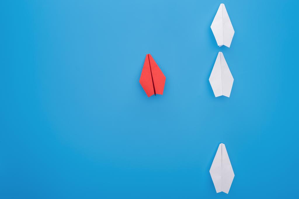 Flat lay with white and red paper planes on blue - Photo, Image
