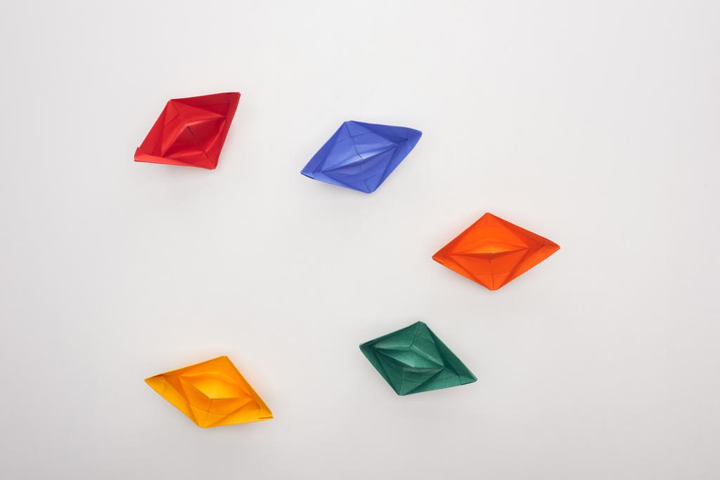 Top view of colorful paper boats on white surface - Photo, Image