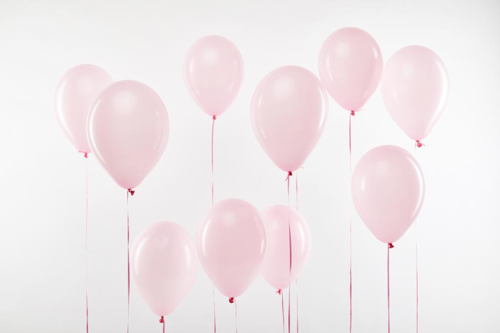白で隔離装飾的なピンクの気球の背景 - 写真・画像