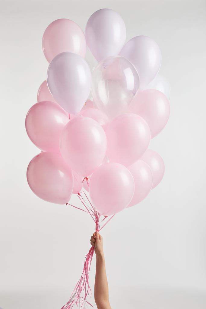 cropped view of girl holding pink air balloons isolated on white - Photo, Image