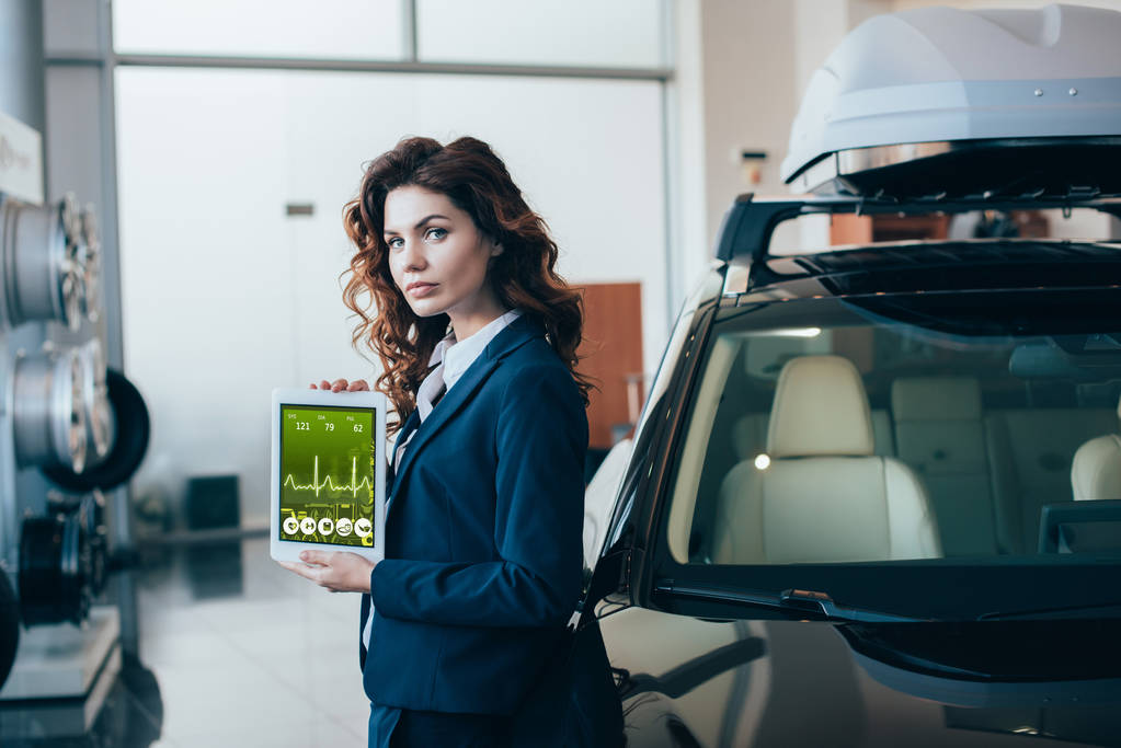 confident businesswoman holding digital tablet with heartbeat rate on screen - Photo, Image