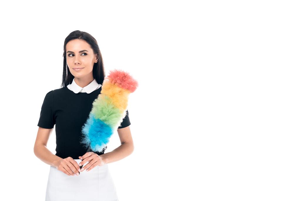 Brunette maid in uniform holding duster isolated on white - Photo, Image