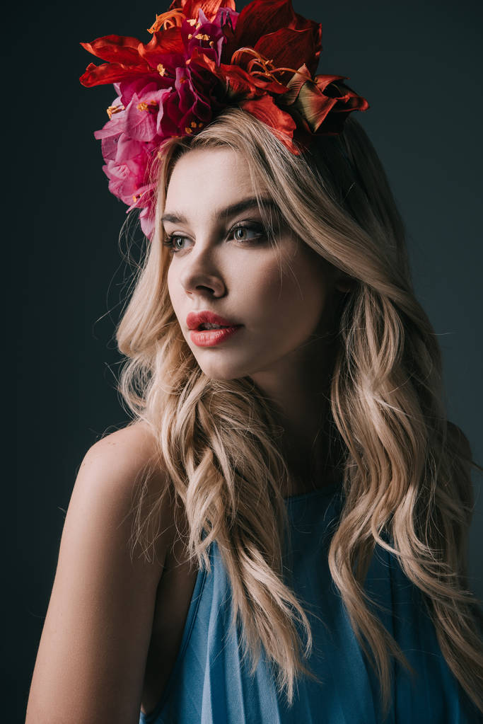 beautiful and blonde woman in colorful wreath looking away isolated on black - Photo, Image