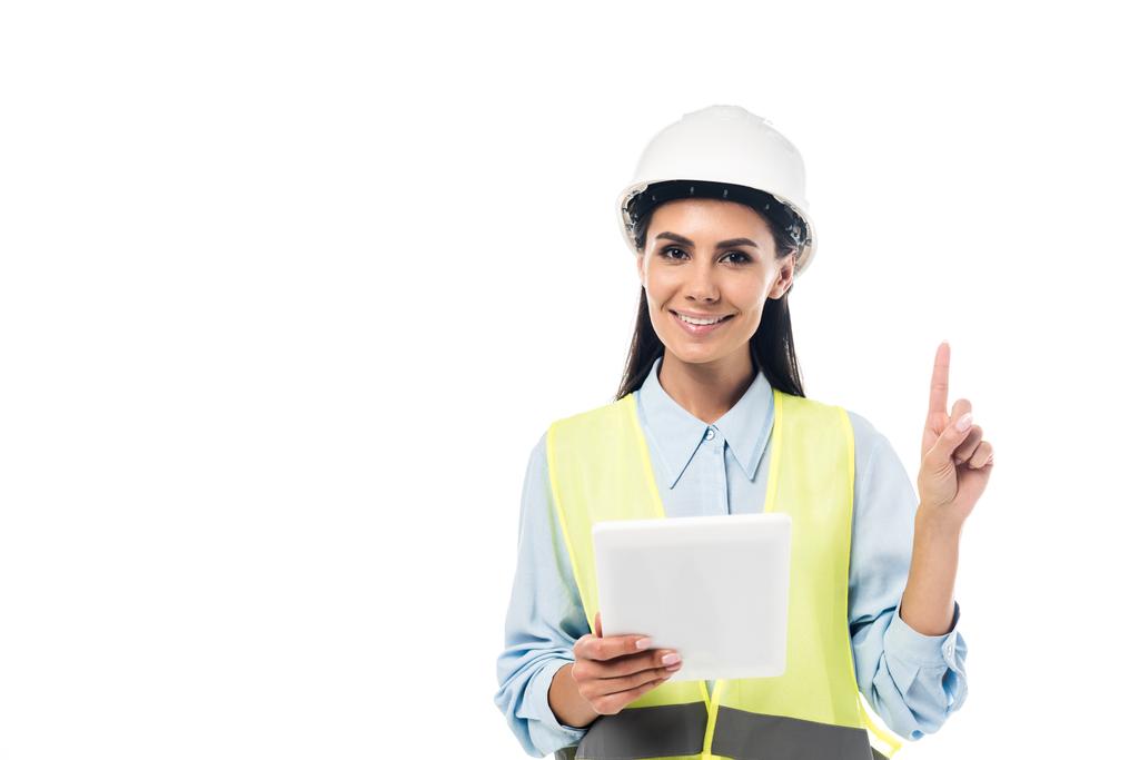Engineer in safety vest using digital tablet and pointing with finger isolated on white - Photo, Image