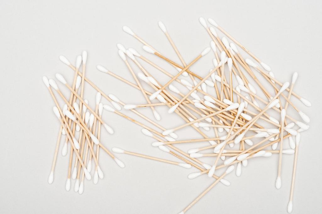 top view of scattered cotton swabs on grey background - Photo, Image