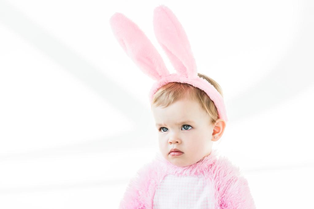 adorable pensive baby in bunny ears headband looking away isolated on white - Photo, Image