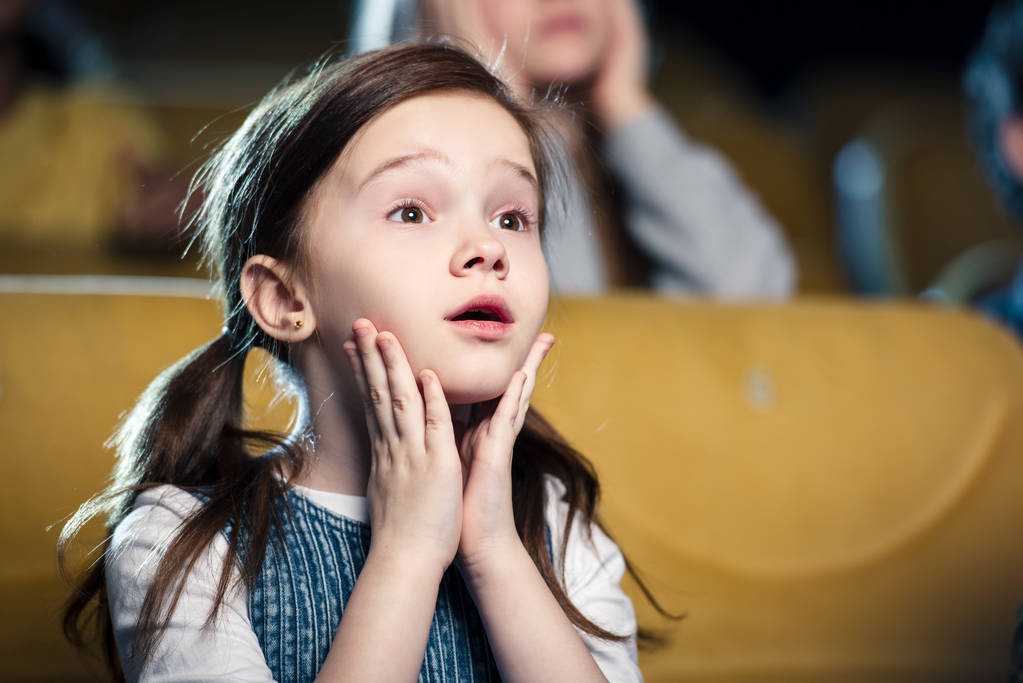 selective focus of cute worried child watching movie in cinema - Photo, Image