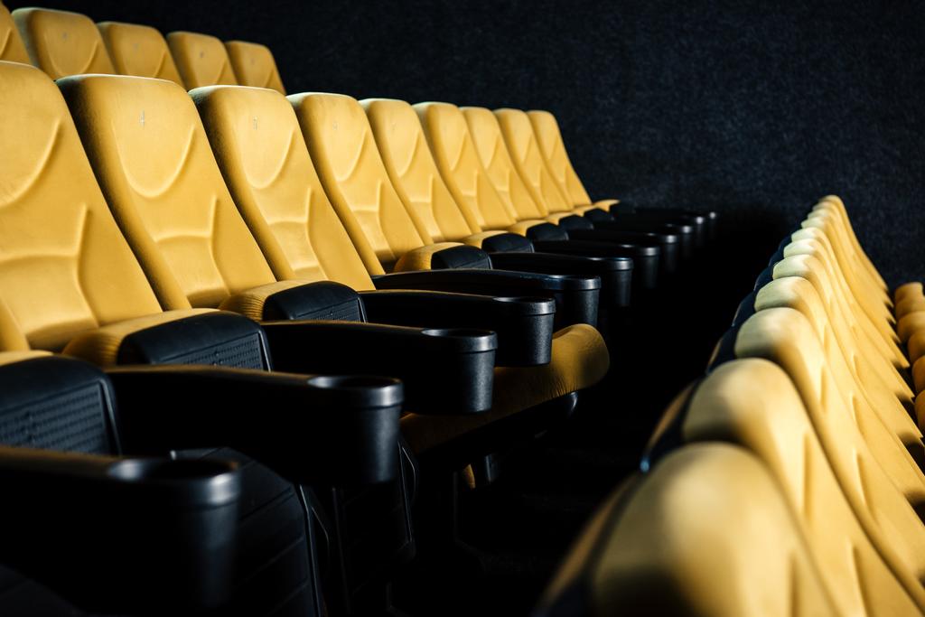 selective focus of comfortable orange cinema seats with cup holders - Photo, Image