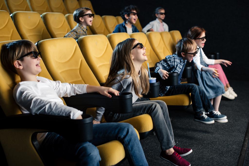 cheerful multicultural friends in 3d glasses watching movie in cinema - Photo, Image