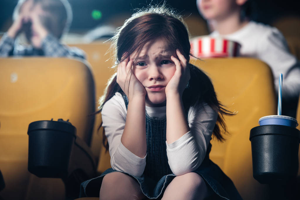 selective focus of cute worried child watching movie in cinema - Photo, Image