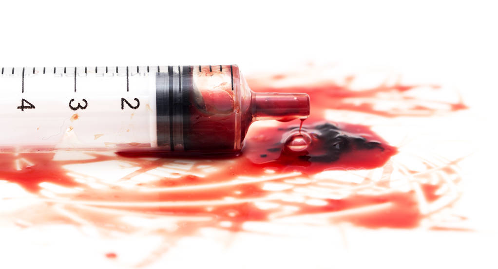 syringe and red blood on white background - Photo, Image