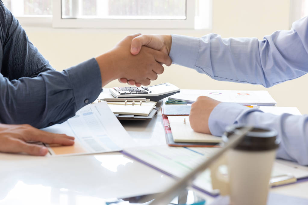Business and finance concept of office working,Teamwork of Businessmen shaking hand after deal investment business plan in office - Photo, Image