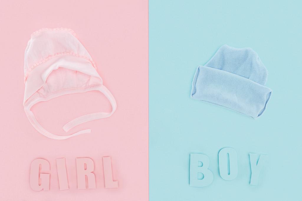 Κορυφαία όψη του καπό και καπέλο, αγόρι ή κορίτσι γράμματα σε ροζ και μπλε φόντο - Φωτογραφία, εικόνα