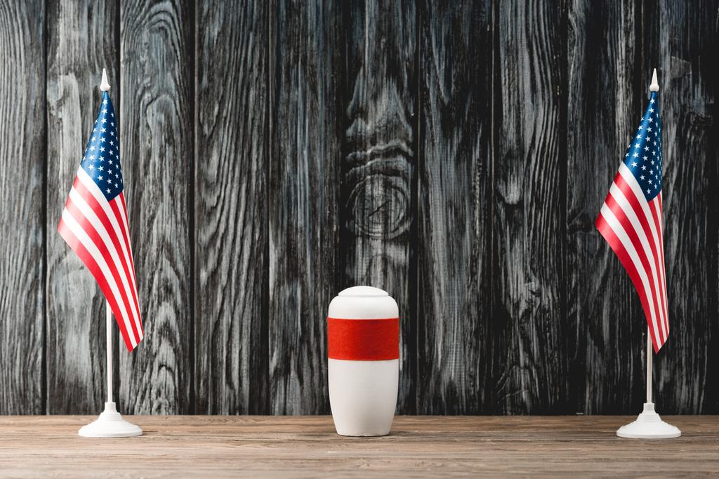 funeral urn with ashes near american flags - Photo, Image