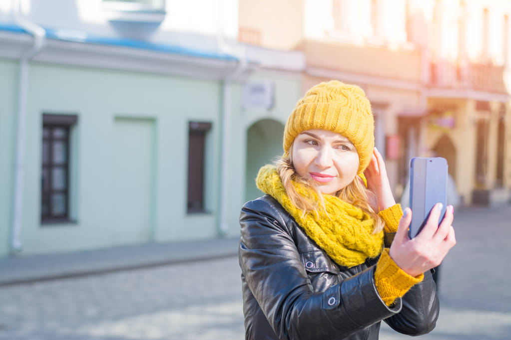nuori tyylikäs hymyilevä kaunis nainen ottaa kuvia selfie hänen puhelimensa
 - Valokuva, kuva