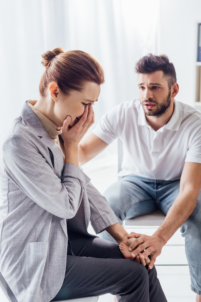 man consoling crying woman during therapy meeting - Photo, Image