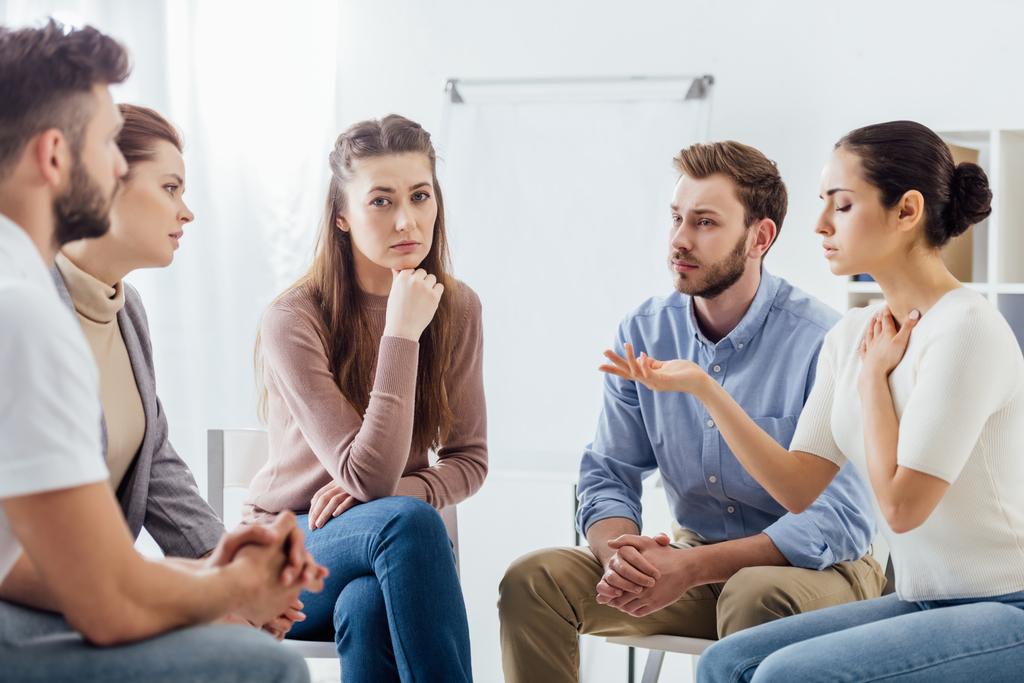 people sitting on chairs and having discussion during support group meeting - Photo, Image