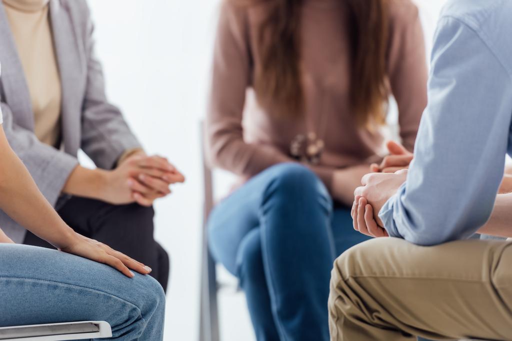 Ausgeschnittene Ansicht von Menschen, die während einer Gruppentherapie-Sitzung sitzen - Foto, Bild