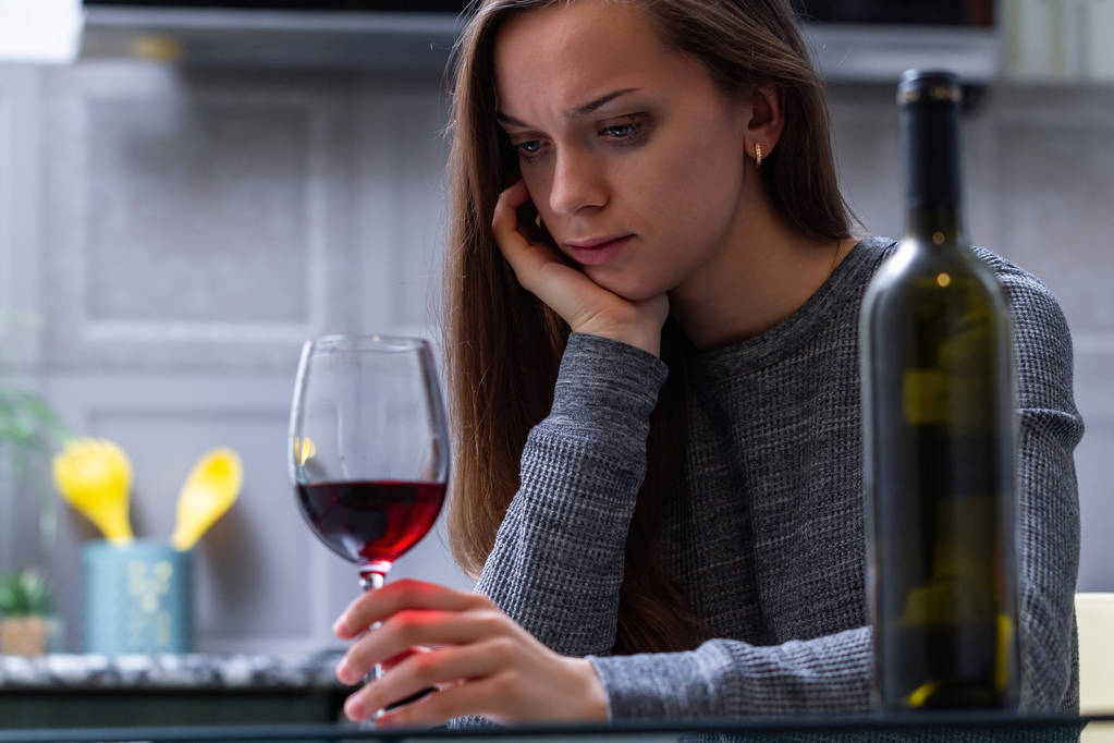 Депрессивная, разведенная плачущая женщина сидит одна на кухне в доме
 - Фото, изображение
