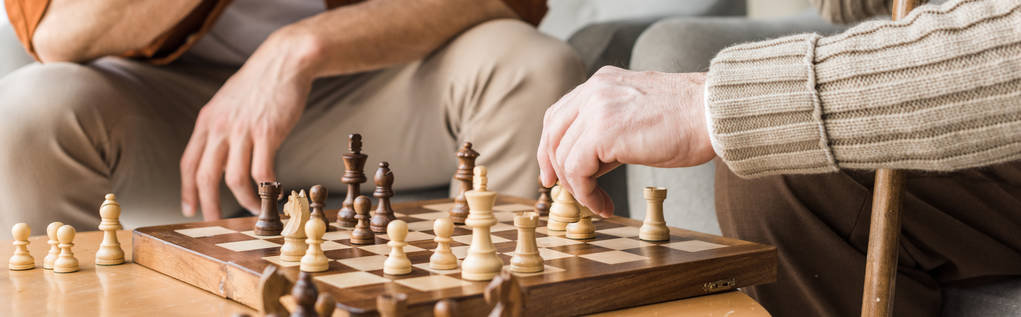 tiro panorâmico de pai e filho aposentado jogando xadrez em casa
 - Foto, Imagem