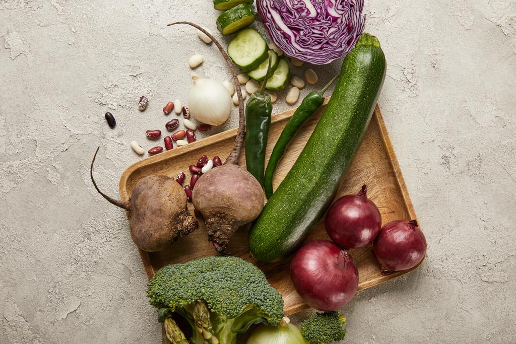 Top view of vegetables and beans on wooden tray - Photo, Image