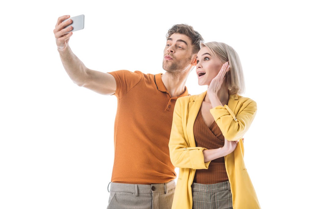 cheerful young man an d woman taking selfie with smartphone isolated on white - Photo, Image