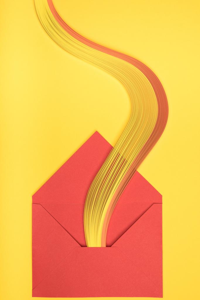 pohled shora otevřené červené obálky s rainbow na žlutém podkladu - Fotografie, Obrázek