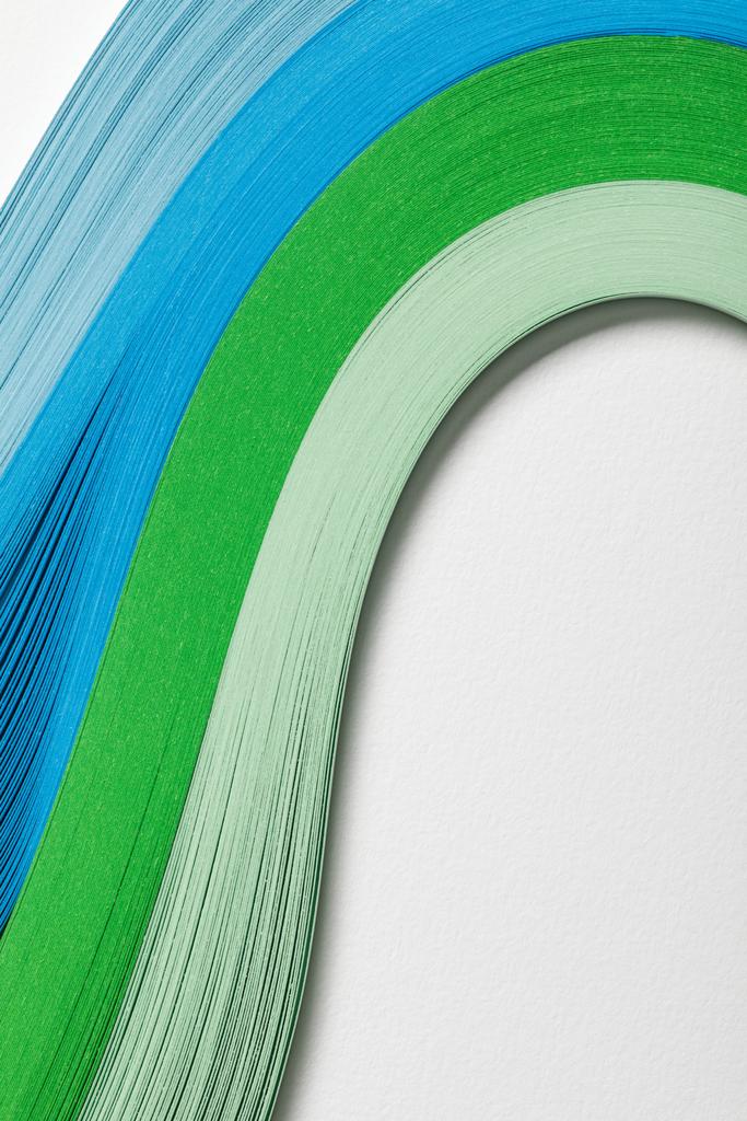 close up of wavy blue and green paper lines on grey background - Photo, Image