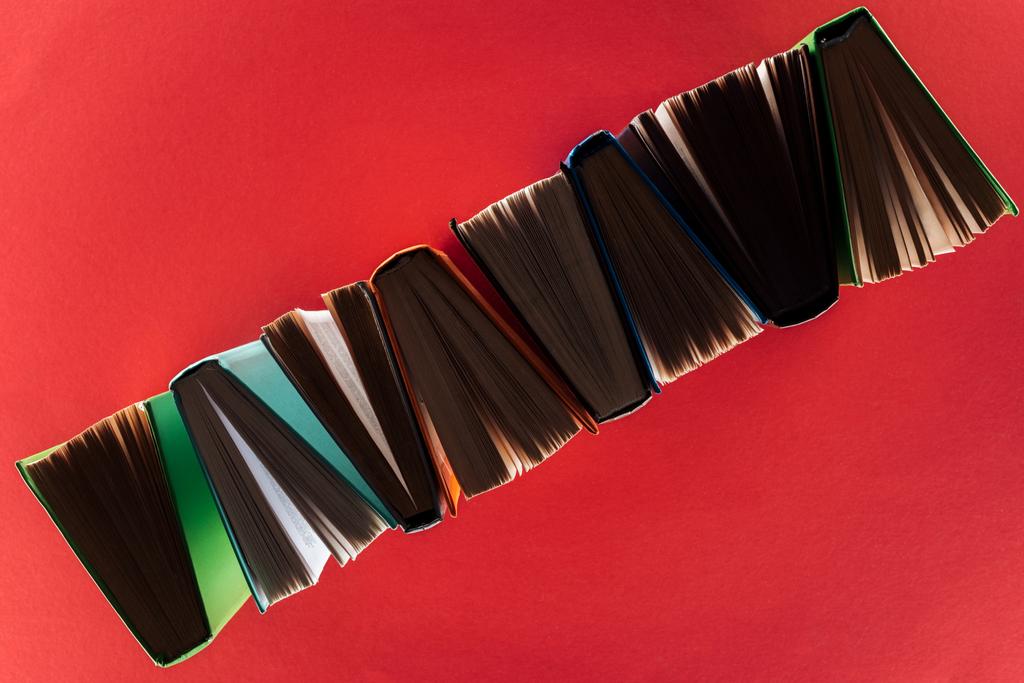 Top view of hardcover books on red surface - Photo, Image