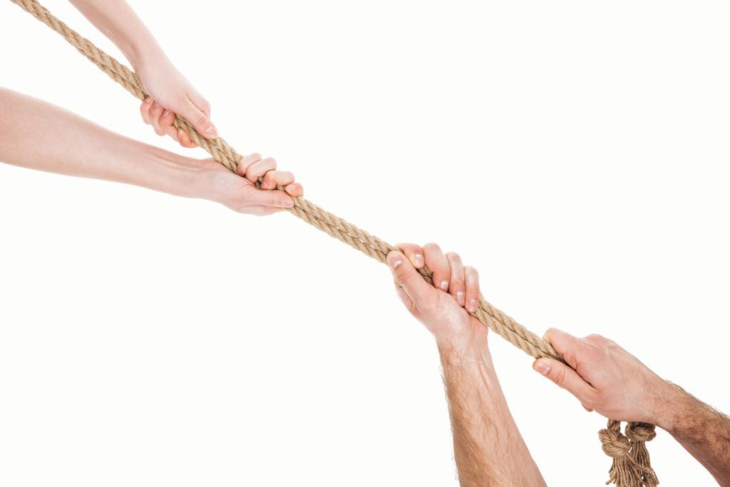 cropped view of man and woman pulling brown rope isolated on white  - Photo, Image