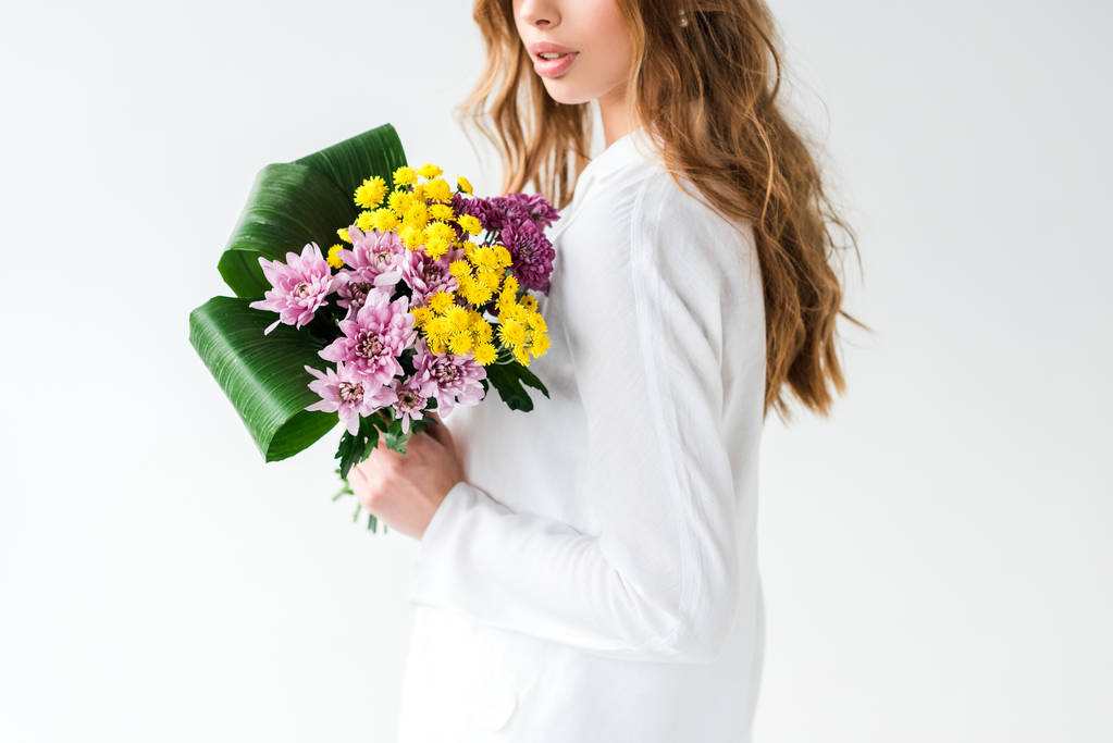cropped view of girl holding bouquet of wildflowers on white  - Photo, Image