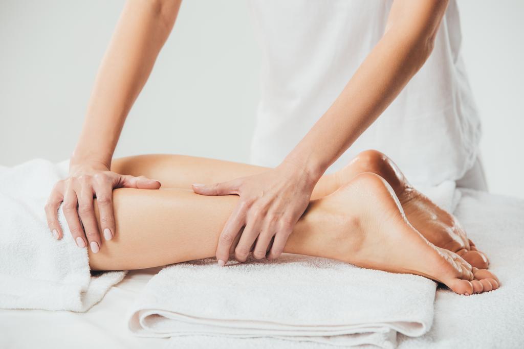 gedeeltelijke weergave van masseur doen voet massage aan volwassen vrouw in Spa - Foto, afbeelding
