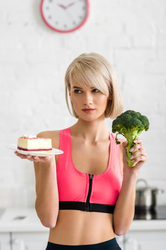 ragazza bionda con broccoli verdi e piattino con dolce torta in mano
 - Foto, immagini