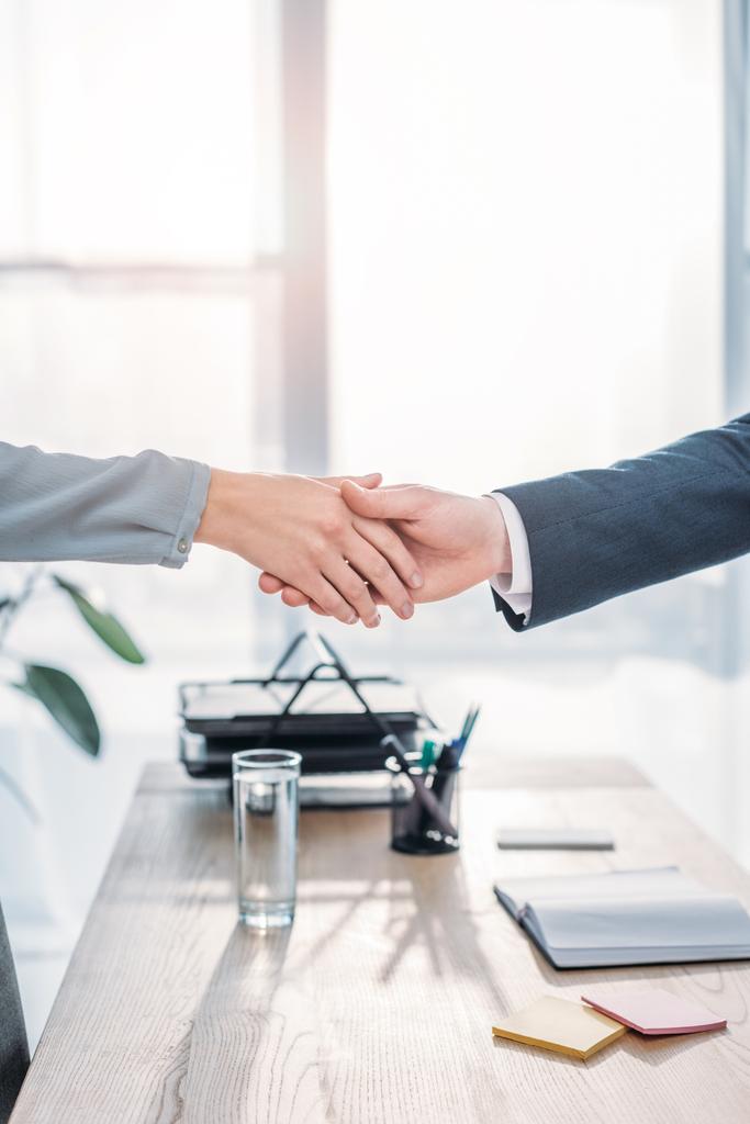 cropped view of recruiter and employee shaking hands in modern office  - Photo, Image
