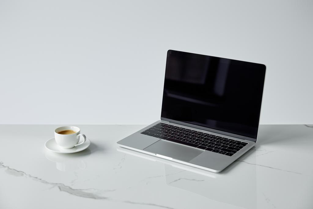 laptop with blank screen and white coffee cup isolated on grey - Photo, Image