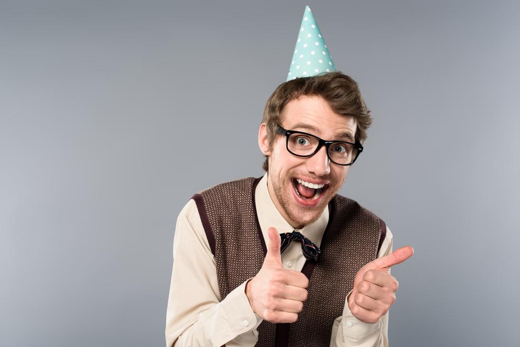 excited man in party cap showing thumbs up - Photo, Image