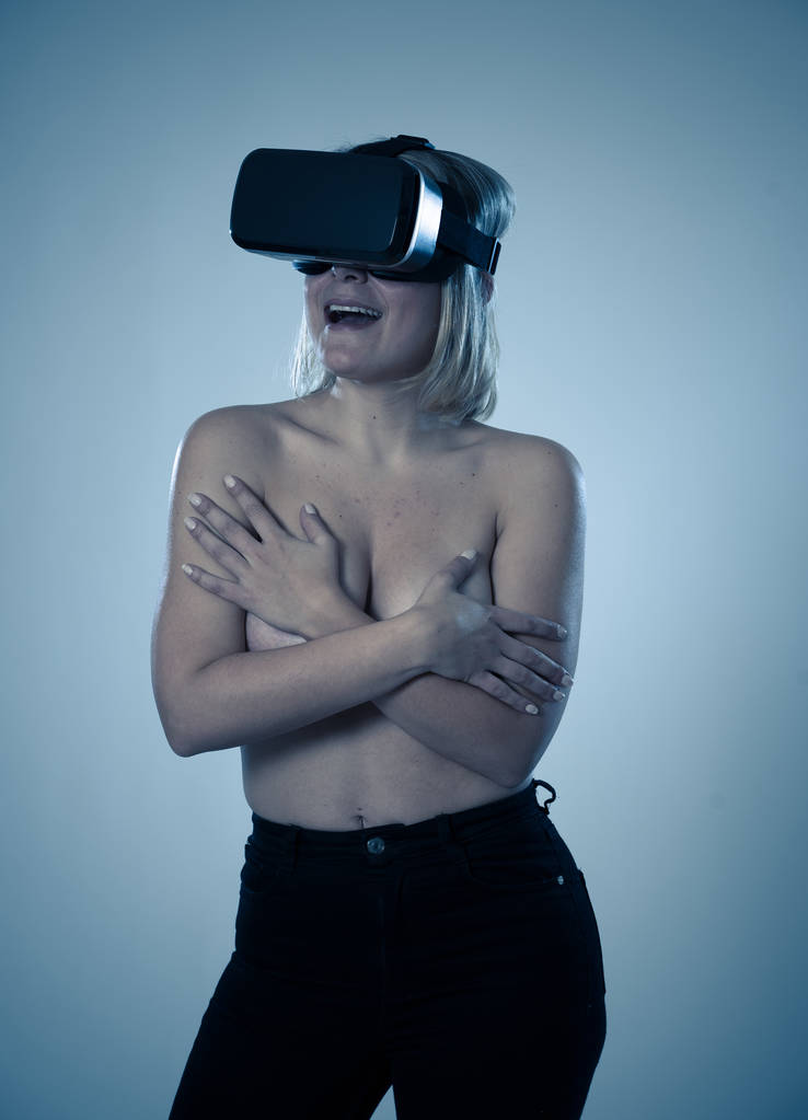 Sensuale donna attraente utilizzando occhiali realtà aumentata o virtuale sensazione eccitato esplorare la sessualità virtuale mentre ottenere topless coprendo il seno. Nel cyber sex VR simulatore e nuova tecnologia
. - Foto, immagini